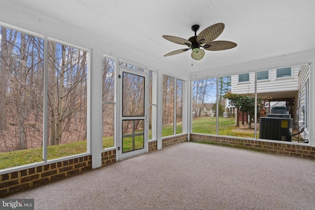 unfurnished sunroom featuring a ceiling fan