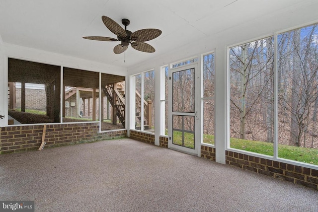 unfurnished sunroom featuring a wealth of natural light and ceiling fan