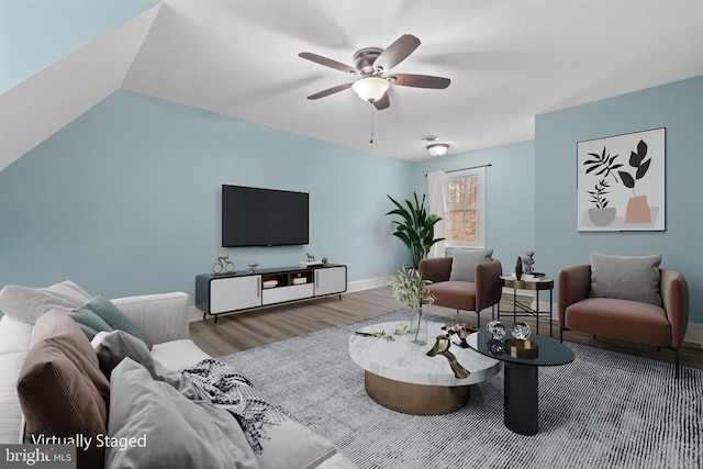 living room featuring a ceiling fan, vaulted ceiling, wood finished floors, and baseboards