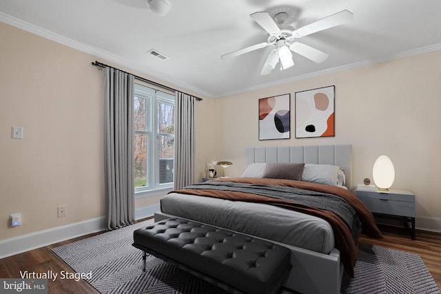 bedroom featuring visible vents, crown molding, baseboards, and wood finished floors