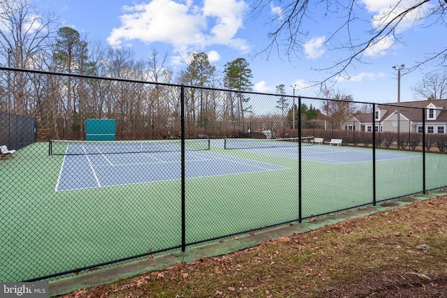 view of tennis court featuring fence