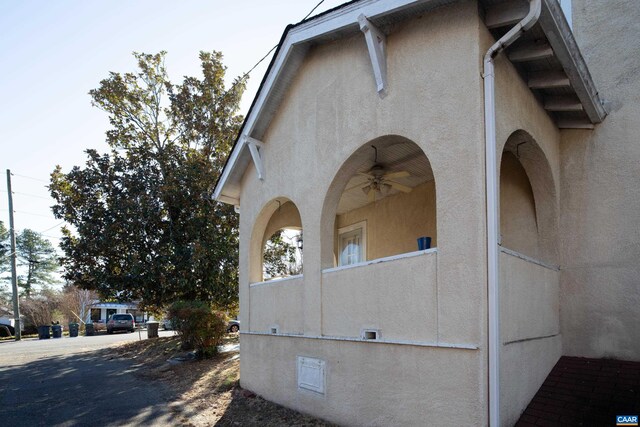 view of side of home with ceiling fan