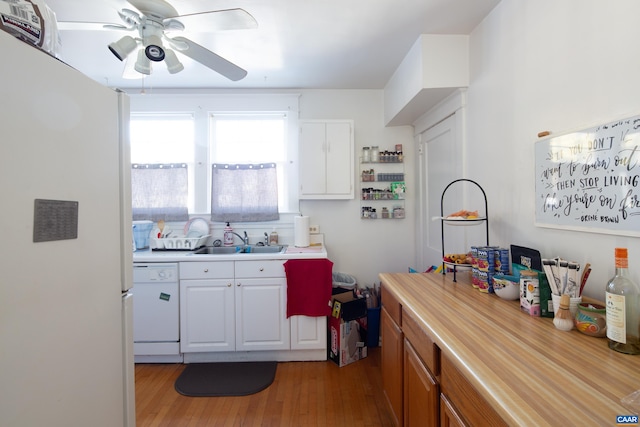 kitchen with sink, white cabinetry, light wood-type flooring, ceiling fan, and white appliances