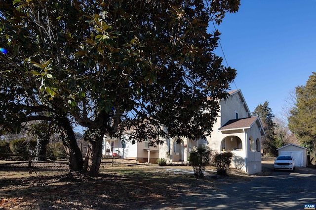 obstructed view of property featuring a garage and an outdoor structure