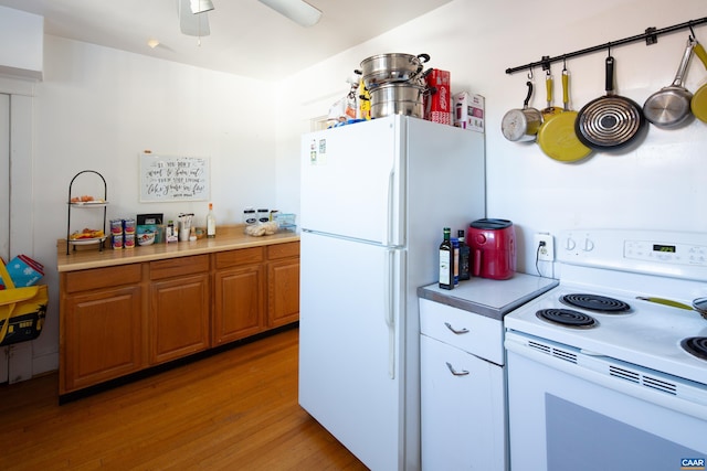 kitchen featuring white appliances, light hardwood / wood-style floors, and ceiling fan