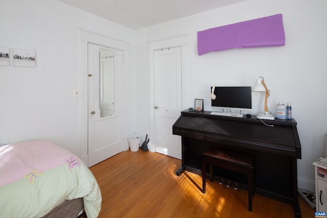 bedroom with hardwood / wood-style floors and a closet