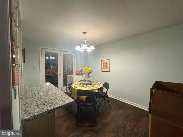 dining room with an inviting chandelier, dark wood-type flooring, and french doors