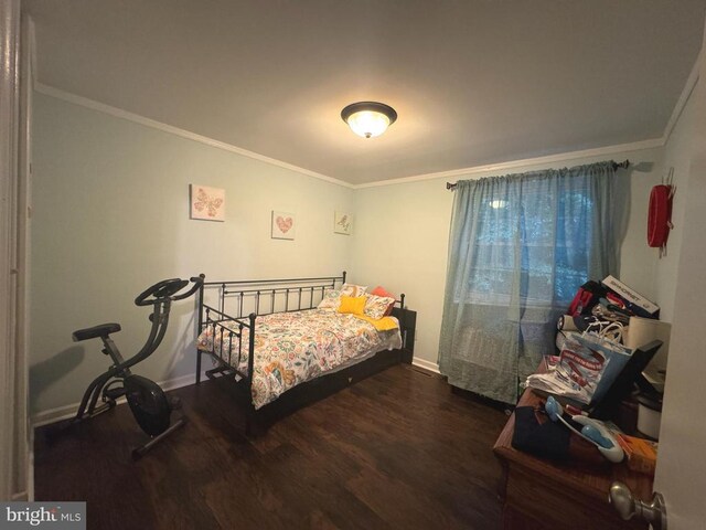 bedroom featuring ornamental molding and dark hardwood / wood-style floors