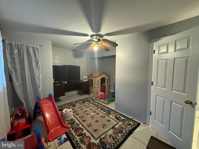 recreation room featuring ceiling fan and light tile patterned flooring