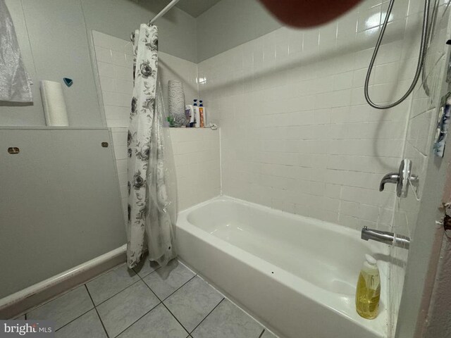 bathroom featuring tile patterned flooring and shower / bath combination with curtain