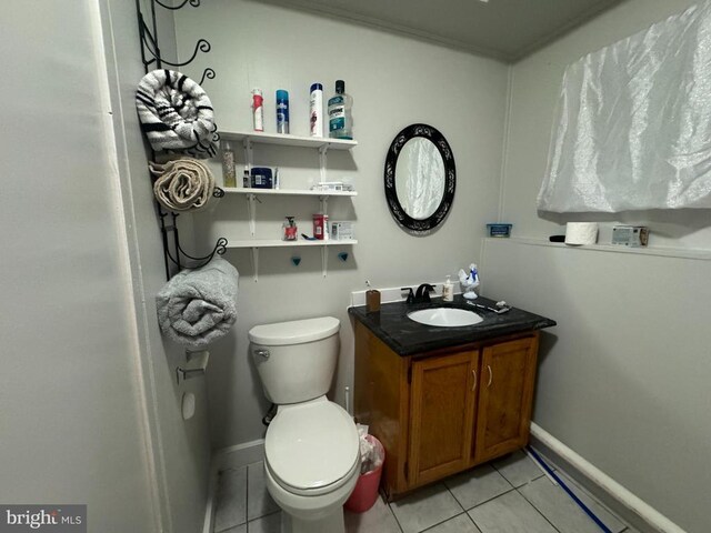 bathroom featuring tile patterned flooring, vanity, and toilet