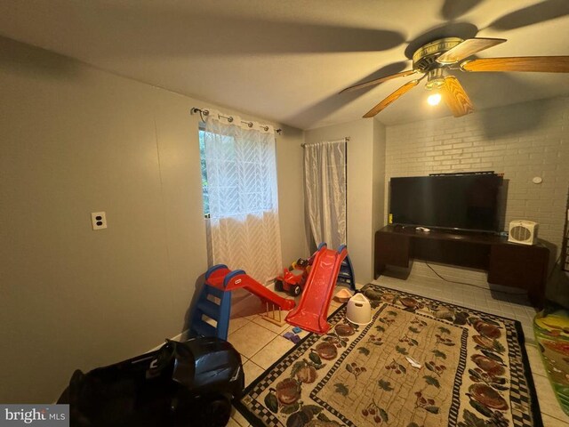 tiled living room featuring ceiling fan