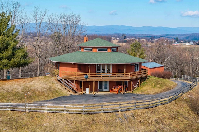 view of front of home with a deck with mountain view