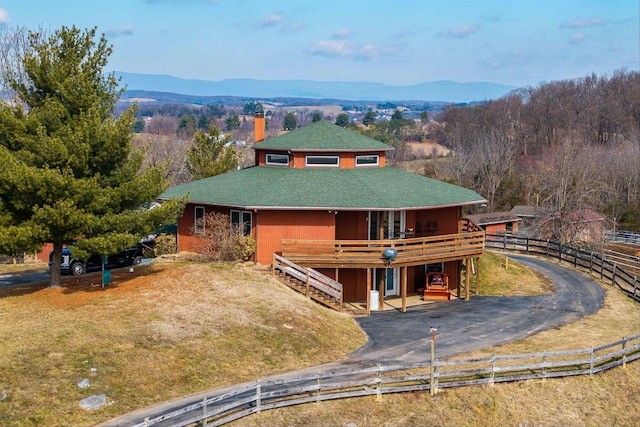 view of front facade with a deck with mountain view