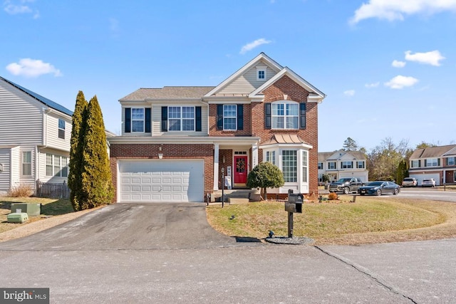 view of front facade featuring brick siding, a garage, a residential view, driveway, and a front lawn