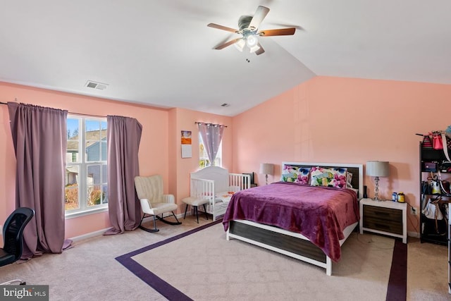 bedroom with carpet floors, visible vents, a ceiling fan, vaulted ceiling, and baseboards