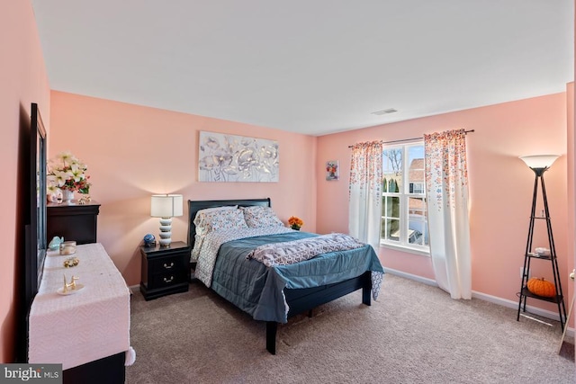 bedroom featuring carpet floors, visible vents, and baseboards