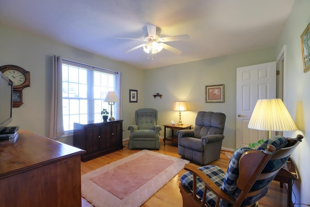 living room with ceiling fan and light hardwood / wood-style floors