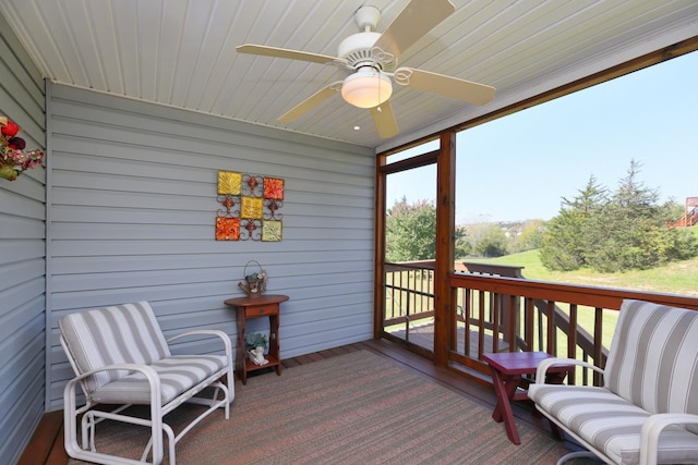 sunroom / solarium featuring ceiling fan