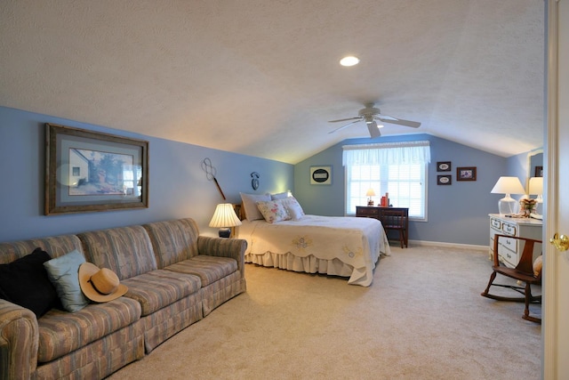 bedroom featuring ceiling fan, light colored carpet, lofted ceiling, and a textured ceiling