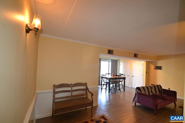 living room featuring baseboards, visible vents, dark wood finished floors, and crown molding