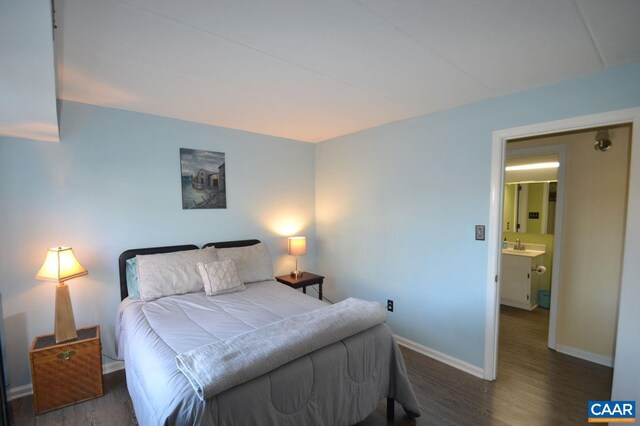 bedroom with dark wood-style floors and baseboards