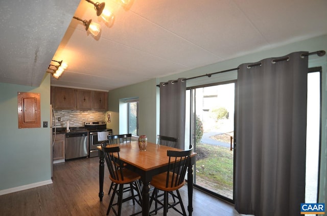 dining room with dark wood-style floors and baseboards