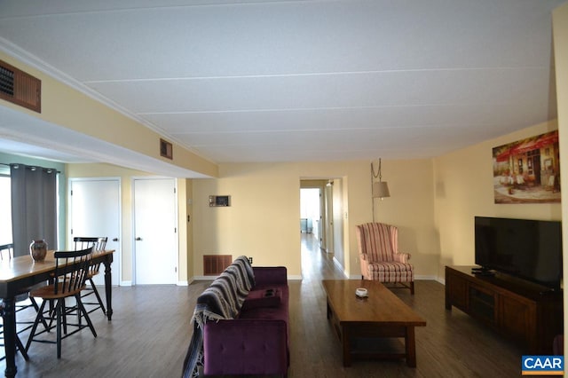 living area with visible vents, dark wood finished floors, and baseboards