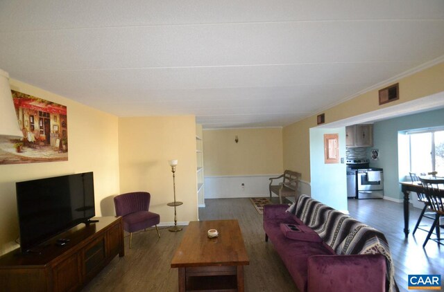 living room with baseboards, visible vents, and dark wood finished floors