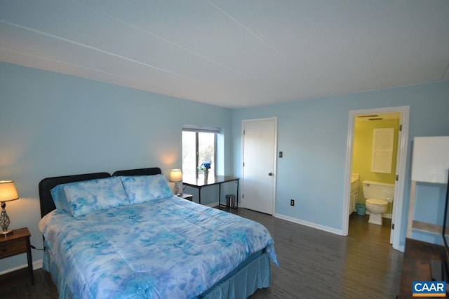 bedroom with dark wood-style floors, baseboards, and ensuite bathroom