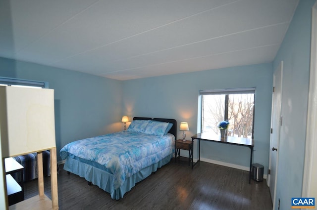 bedroom with dark wood finished floors and baseboards