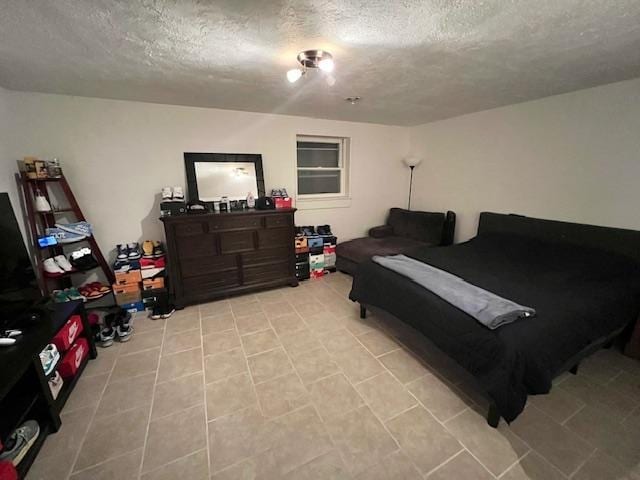 bedroom featuring a textured ceiling and light tile patterned floors