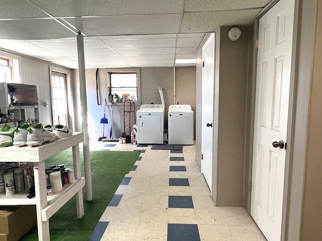 laundry room with light floors, washing machine and dryer, and laundry area