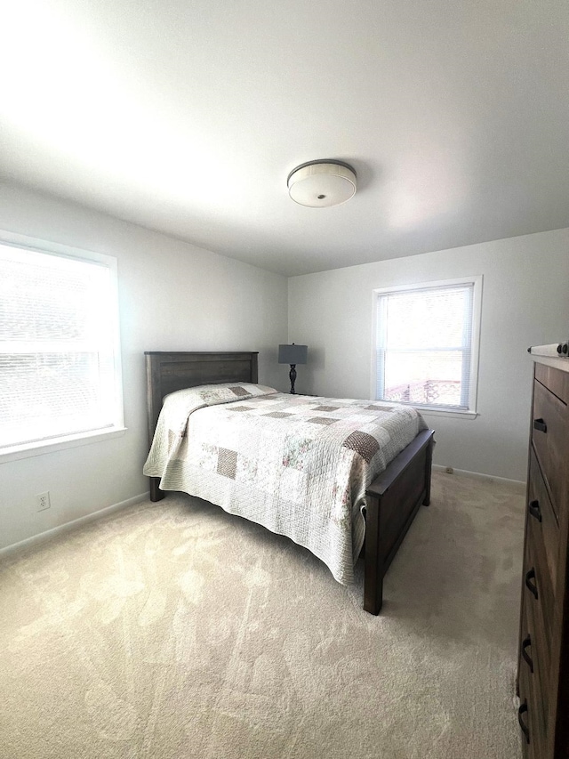 bedroom featuring carpet flooring and baseboards