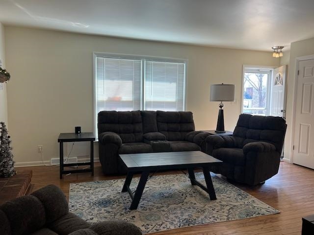 living room featuring wood finished floors and baseboards