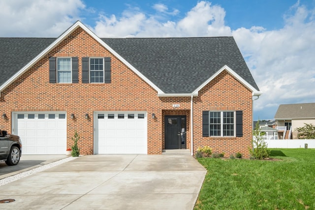 view of front of house with a garage and a front lawn