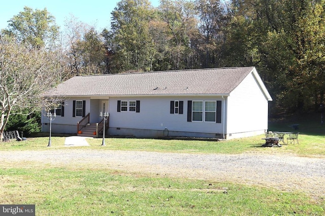 view of front of house featuring a fire pit and a front yard