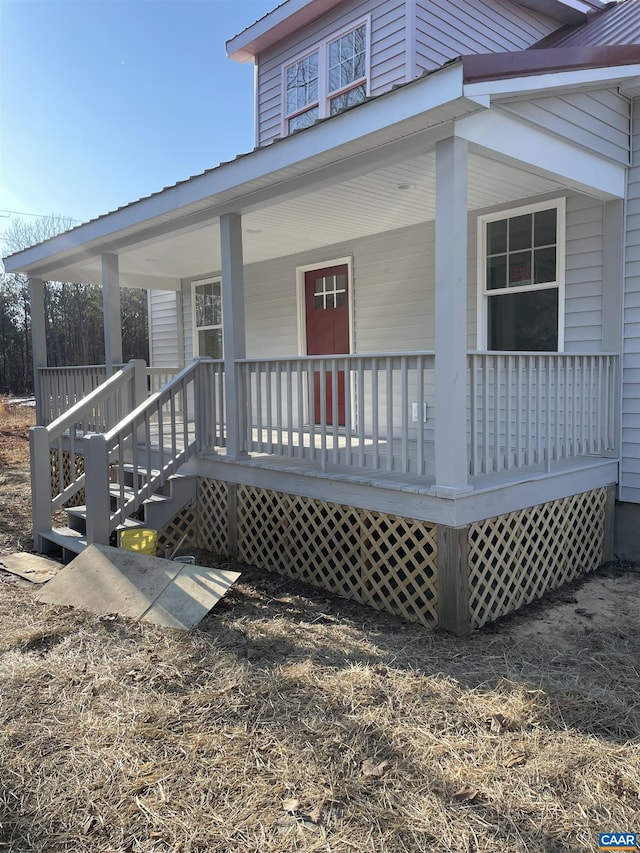 exterior space featuring metal roof and a porch