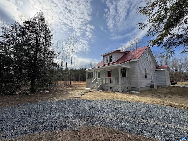 exterior space with covered porch and metal roof