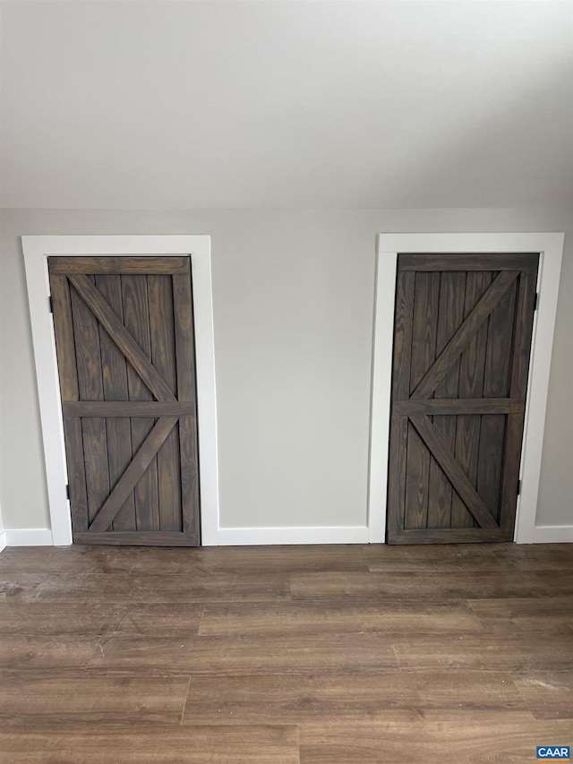 unfurnished bedroom with baseboards and wood finished floors