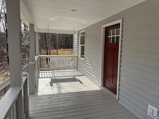 wooden deck featuring covered porch