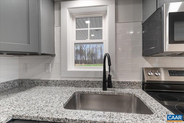 half bath featuring marble finish floor, toilet, vanity, and baseboards