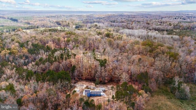 birds eye view of property with a wooded view