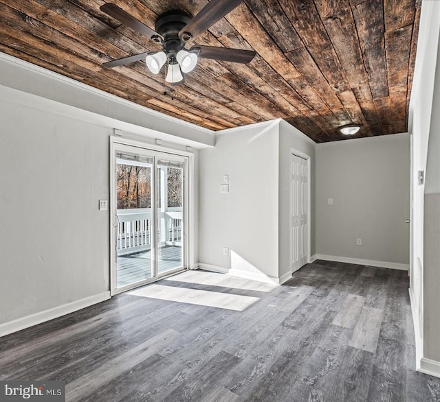 interior space with a ceiling fan, wood finished floors, wood ceiling, and baseboards