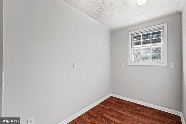 spare room with crown molding, a textured ceiling, and dark hardwood / wood-style flooring