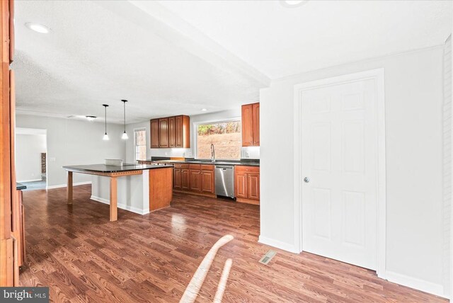 kitchen with a kitchen bar, a center island, hanging light fixtures, dark hardwood / wood-style flooring, and dishwasher