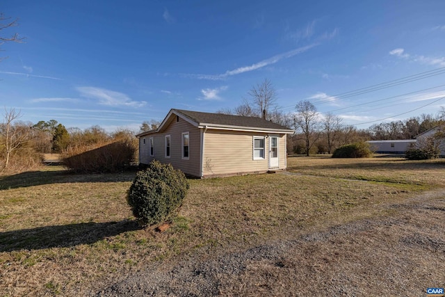 view of side of property featuring a yard