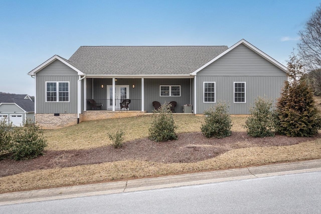 ranch-style home with covered porch, roof with shingles, and crawl space