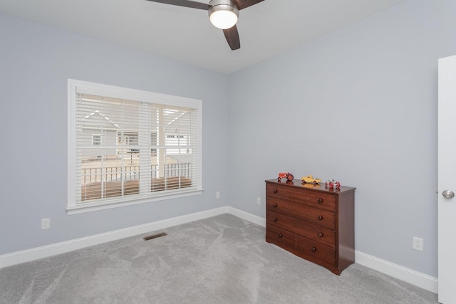 spare room featuring a ceiling fan, carpet flooring, visible vents, and baseboards