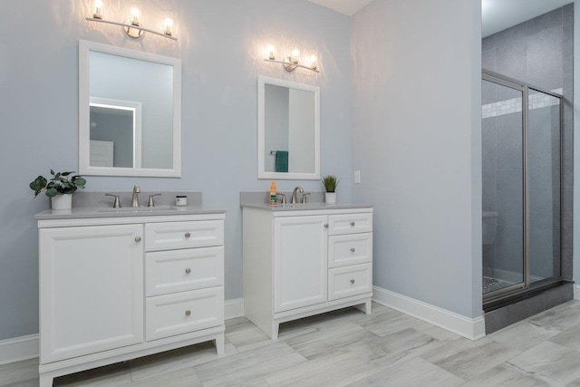 bathroom with two vanities, a sink, and a shower stall